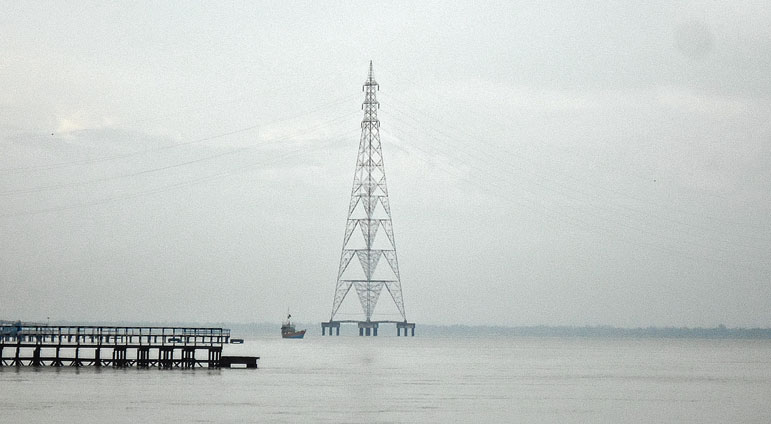 নদীর বুকে বসেছে বিদ্যুতের টাওয়ার।