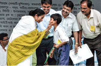 শিক্ষাশ্রী প্রকল্পে এক পড়ুয়াকে আর্থিক সাহায্য করছেন মুখ্যমন্ত্রী। ডাকবাংলো মাঠে। ছবি: বিশ্বজিৎ রায়চৌধুরী।