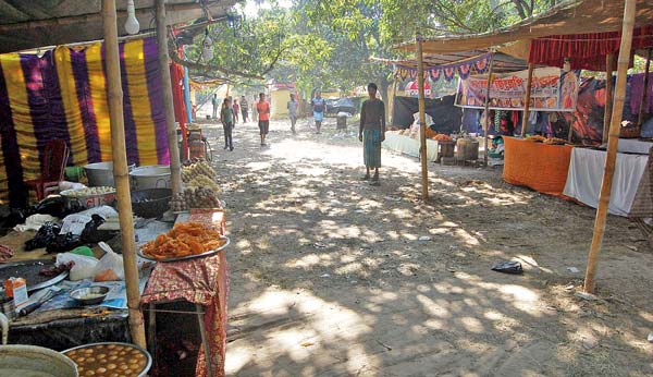 Puja organizers waits outside the ATM koisk for money