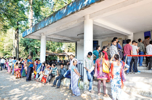 People are waiting in a long ATM queue