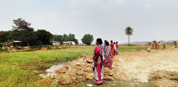 Women guarding pond to prevent it’s filling