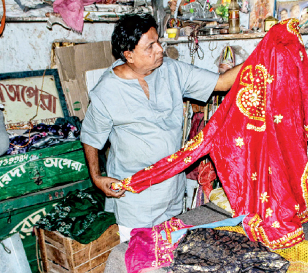 Female running a tea stall after loosing hope of income from theatre