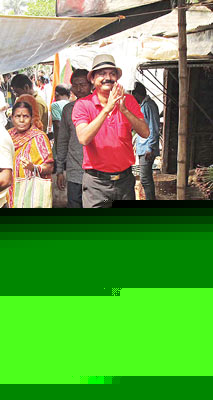 Candidate helps people to choose fish from market in Nabadip for election