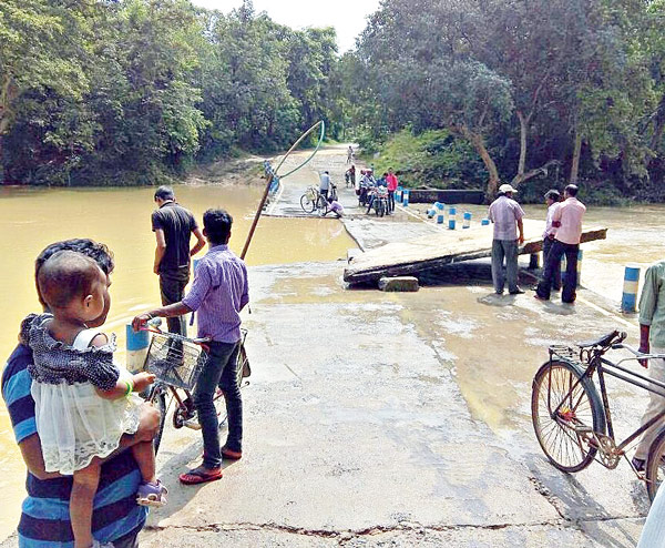 Causeway broken away by overflowing river