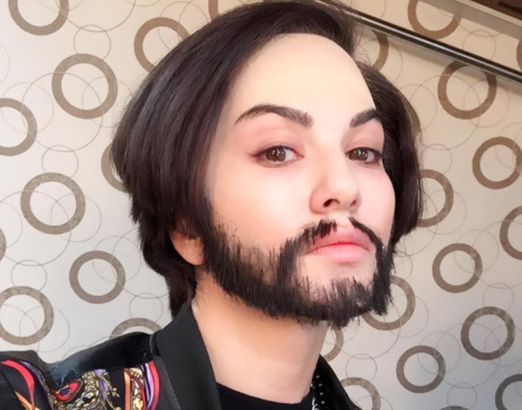 গেস করাটা সত্যিই একটু কঠিন। আসল উত্তরটা দিলে আপনি চমকে যাবেন। ইনি সানি লিওন। বিশ্বাস না হলেও এ কথা সত্যি। এটি সানি লিওনের ছবি। সানি নিজেই তা শেয়ার করেছেন সোশ্যাল মিডিয়ায়। ক্যাপশনে তিনি লিখেছেন, ‘‘আমাকে ছেলে সাজানো হয়েছে...আমাকে আমার বাবা ও ভাইয়ের মতো দেখতে লাগছে... অদ্ভুত...।’’