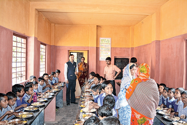 পাতে-হাত: লাইন দিয়ে খাচ্ছে খুদেরা। নিজস্ব চিত্র