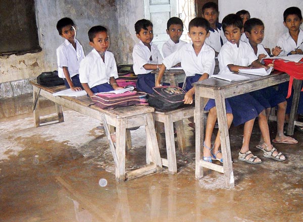 Students have to use towel in their school in the rainy season
