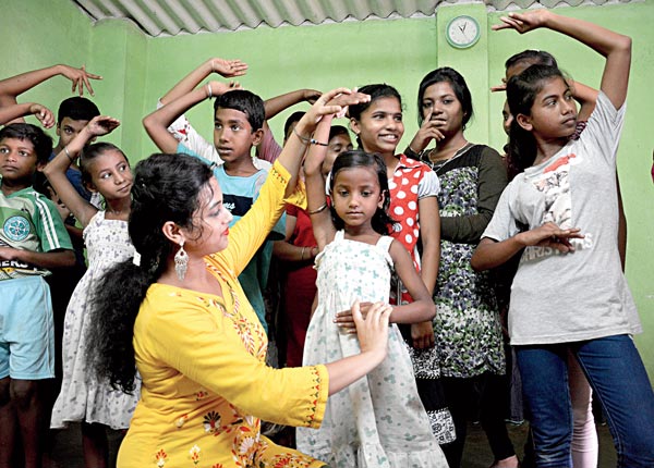 Two engineering students give dance training to the children of slum area