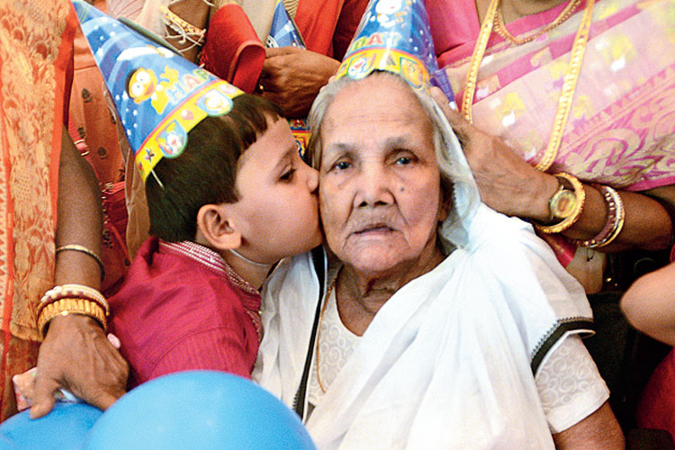 Elderly woman's 100th birthday celebrated by cutting the cake