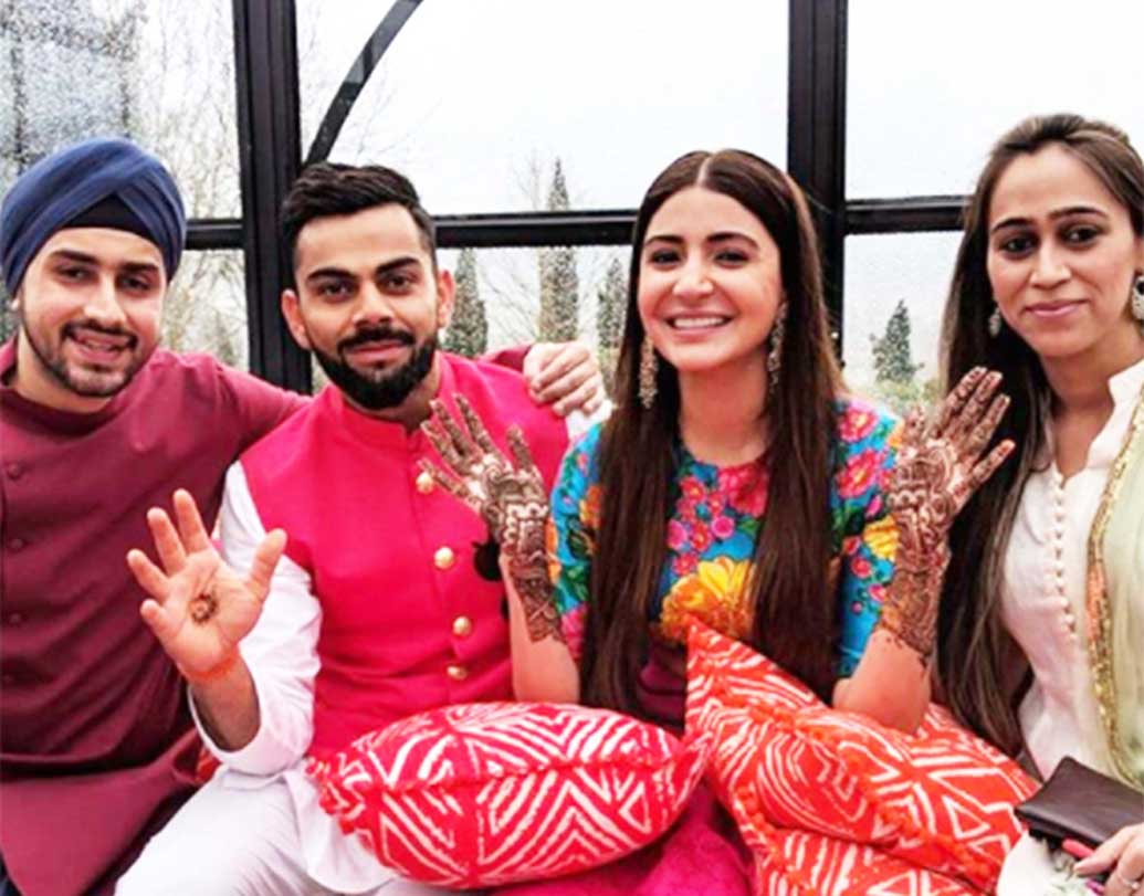 মেহেন্দি সেরেমনিতে হলুদ, নীল, ফ্লোরাল ডিজাইনের পিঙ্ক লেহঙ্গা পরেছিলেন অনুষ্কা।