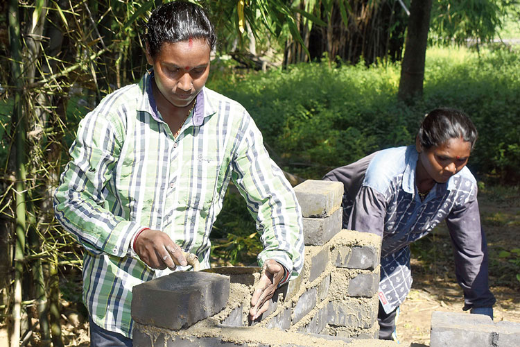 Woman of Purulia working as a mason and making toilets