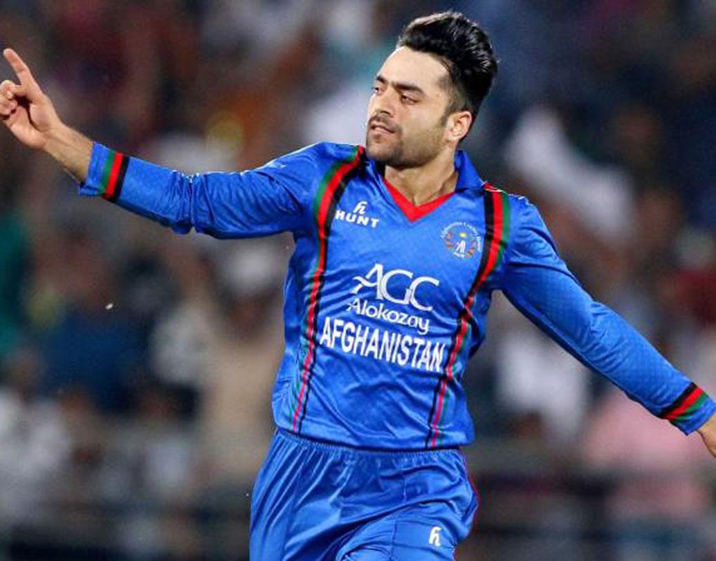 টি-২০ ফর্ম্যাটে আফগান দলের অধিনায়ক রশিদ খানকেই দ্বাদশ ব্যক্তি হিসেবে বেচে নিয়েছেন ভন! ম্যাচ বুঝতে পারার ক্ষমতা, টি-২০-তে ঈর্ষনীয় বোলিং অ্যাভারেজ ও সেরা তরুণ খেলোয়াড়দের মধ্যে অন্যতম হয়ে ওঠার ক্ষমতার জোরেই রশিদ এই দলে প্রবেশ করতে পেরেছেন বলে মনে করছেন অনেকেই।