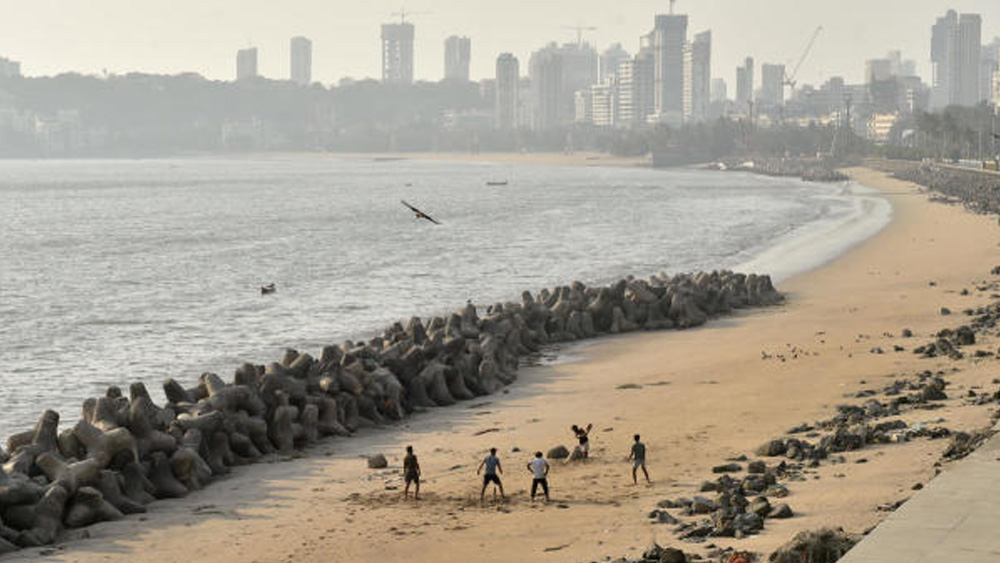 আইকনিক মেরিন ড্রাইভ এখন জনশূন্য। তার মাঝেই চলছে নিয়মভাঙা বেপরোয়া ক্রিকেট খেলা।