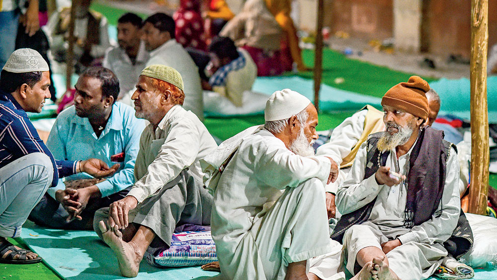 দিনযাপন: হিংসাদীর্ণ রাজধানীতে আপাতত ঠাঁই ইদগার ত্রাণ শিবিরে। মঙ্গলবার মুস্তাফাবাদ এলাকায়। ছবি: পিটিআই।