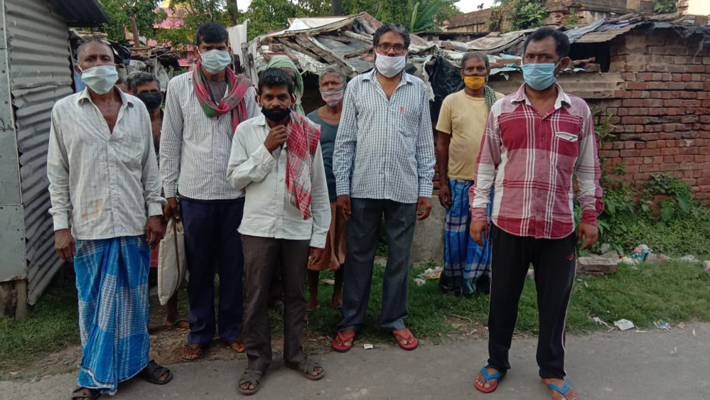 ঝাড়খন্ড রওয়ানা হওয়ার আগে ইছাপুরে পরিযায়ী শ্রমিকরা। সঙ্গে কংগ্রেস নেতা অশোক ভট্টাচার্য।—নিজস্ব চিত্র।