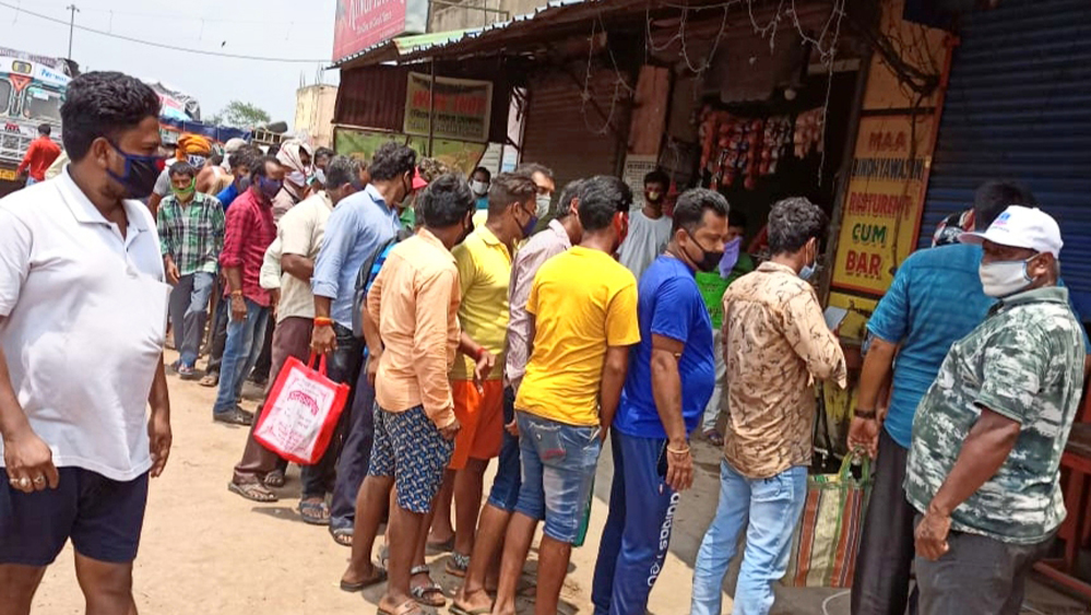 ধূলাগড়ি আনাজ বাজারে মদের দোকানে লাইন। ছবি: সুব্রত জানা

