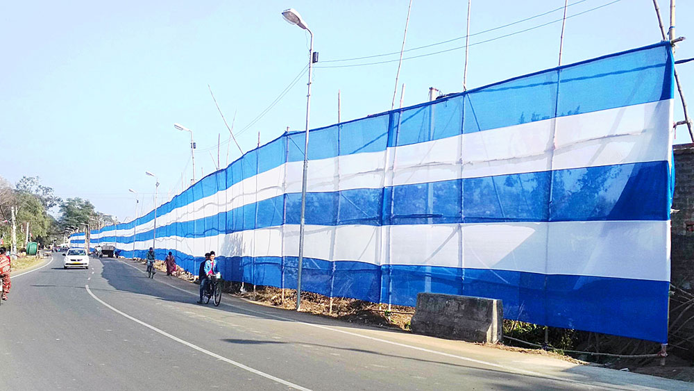 blue white curtain is used to cover dumping ground from Mamata Banerjee in Bardhaman