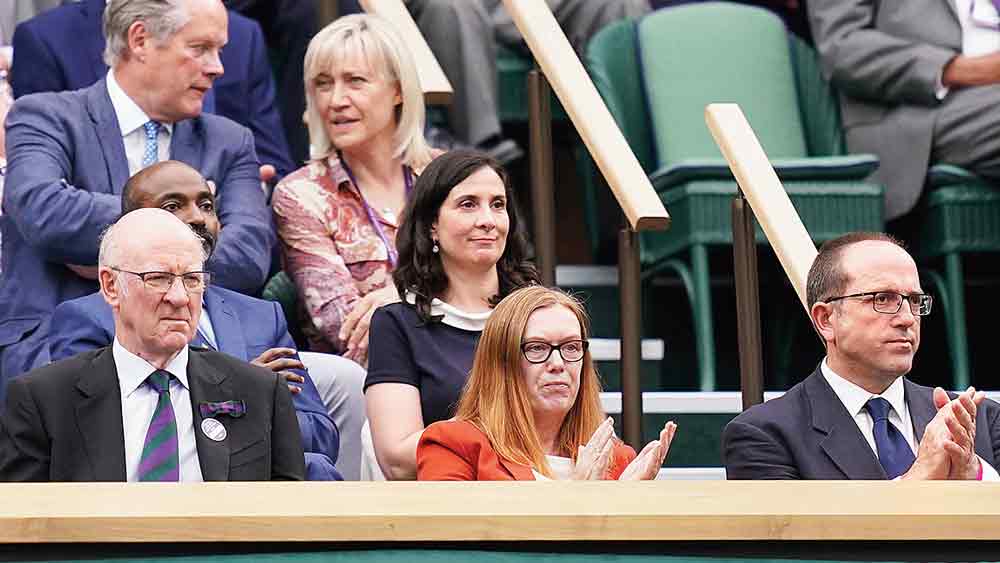 মধ্যমণি: উইম্বলডনে খেলা দেখছেন সারা গিলবার্ট (কমলা পোশাকে)।