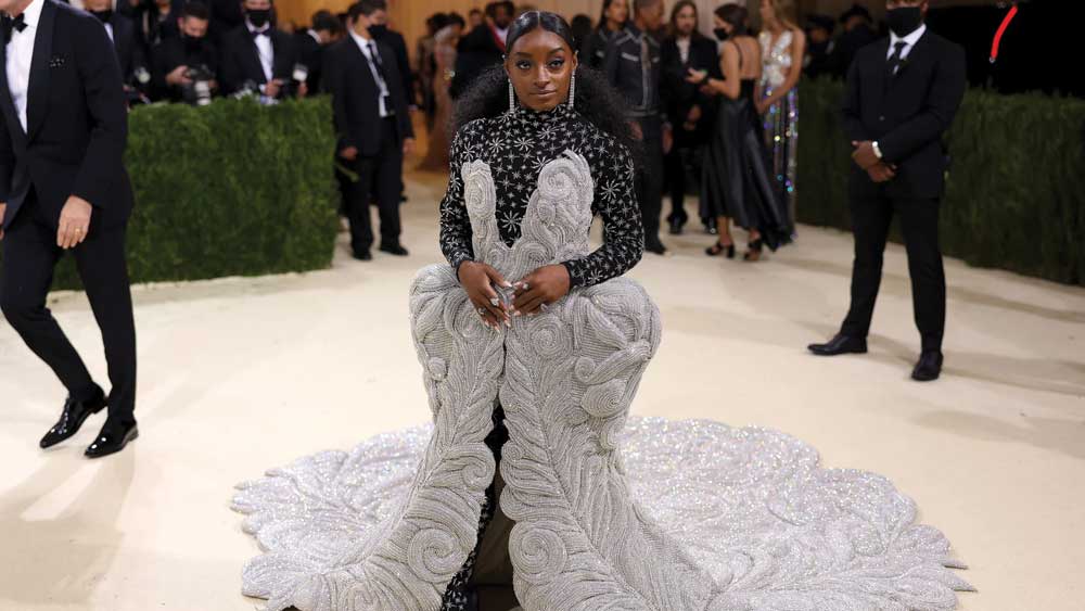 অলিম্পিকে এক ভাবে দেখা গিয়েছিল তাঁকে। চর্চাও কম হয়নি। এ বার নজর কাড়ল জিমনাস্টের সাজ। ৯৮ পাউন্ড ওজনের এই পোশাকেই হোয়াইট কার্পেটে দেখা গেল সোনা জয়ী অ্যাথলিট সিমোনে বাইলসকে। 