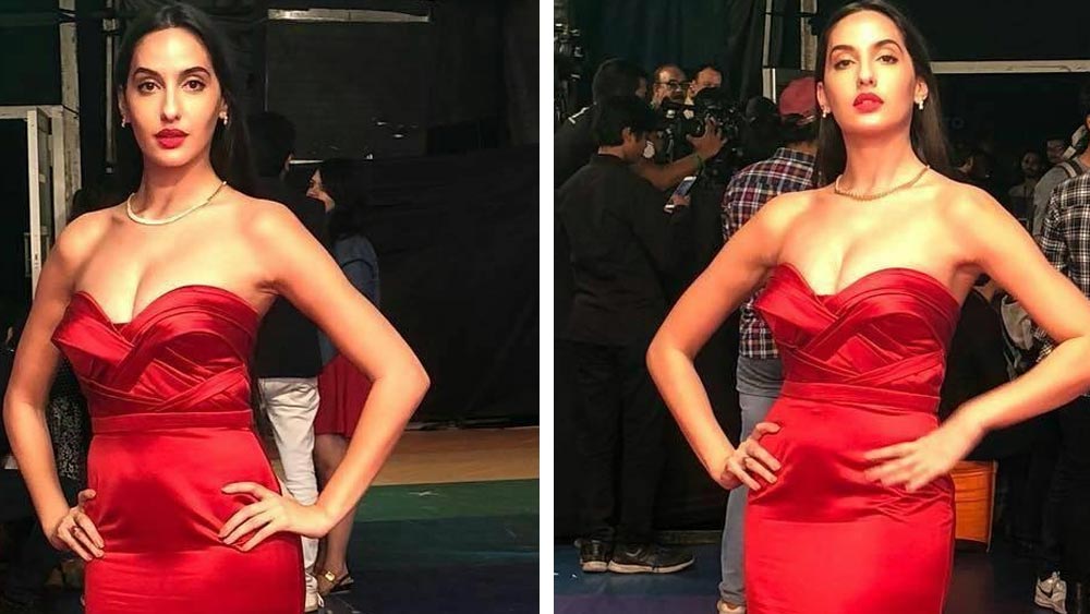 কেবল গাউন নয়, লাল শর্ট ড্রেসেও মোহময়ী অবতারে প্রকাশ্যে এসেছেন নোরা। কানে ও গলায় হীরের স্লিক গহনা, খোলা চুল, লাল লিপস্টিকে নোরার এই সাজে সেজে উঠতে পারেন আপনিও!