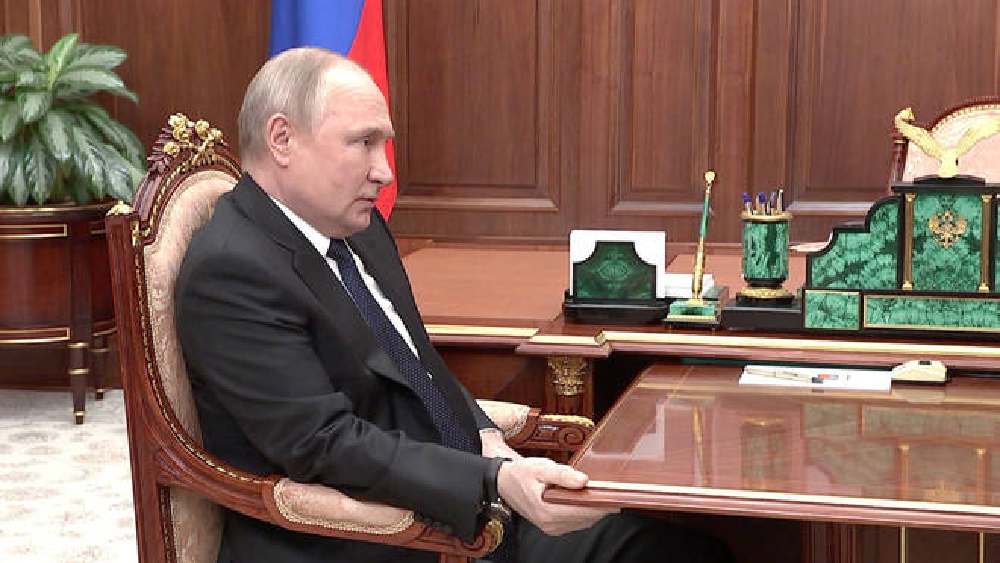 কোনও মতে চেয়ারে বসে টেবিল আঁকড়ে রয়েছেন পুতিন।