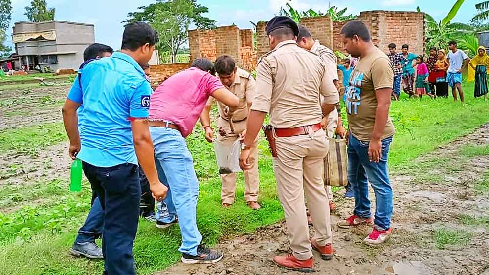 অনুসন্ধান: নারায়ণতলা গ্রামের এই মাঠে পড়েছিল দু’টি দেহ। নমুনা সংগ্রহ করছেন তদন্তকারীরা।