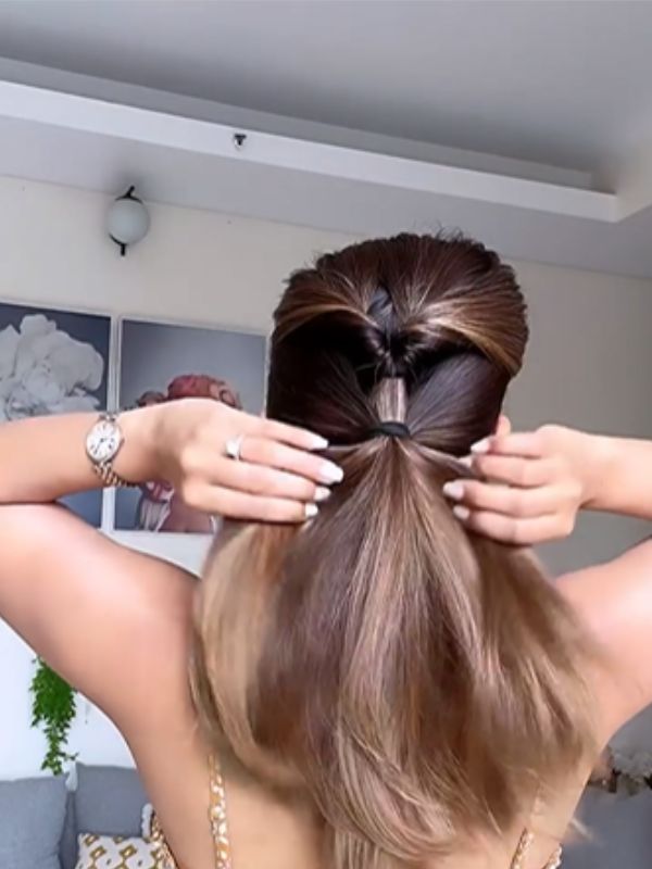  বাকি চুলের নীচের অংশ পুরোটা একসঙ্গে নিয়ে বেঁধে ফেলুন আর একটি হেয়ার টাই দিয়ে। 