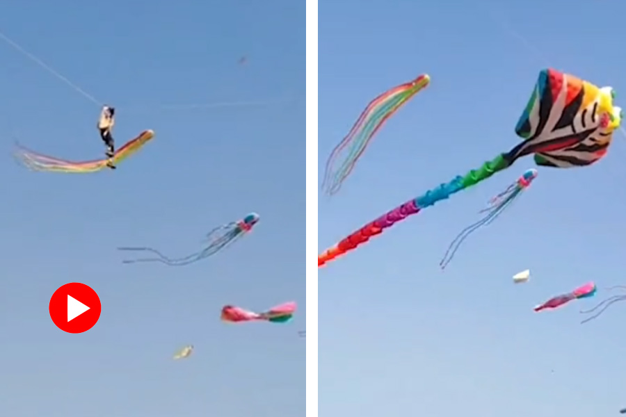 Man shows dangerous stunt while flying kite in China.