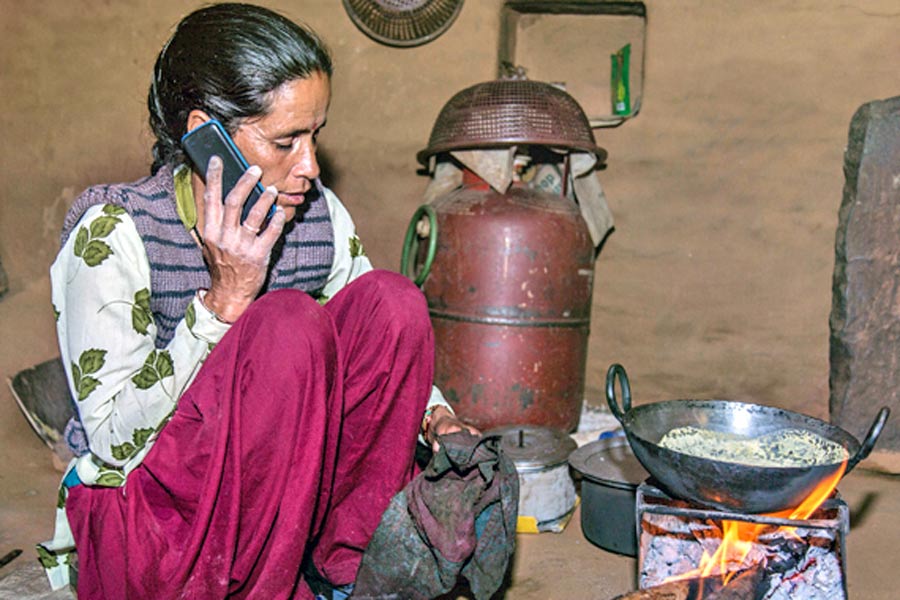 A Photograph of  a woman calling while cooking 