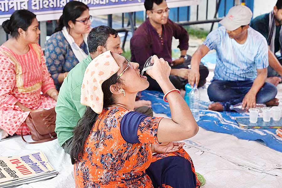 A Photograph of a woman drinking water while doing protest