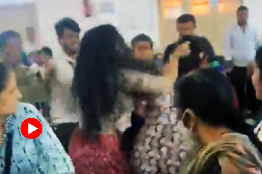 Two women fighting over a saree in Bengaluru Yearly Saree Sale.