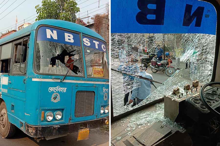 A government bus is demolished by BJP's strike supporters.
