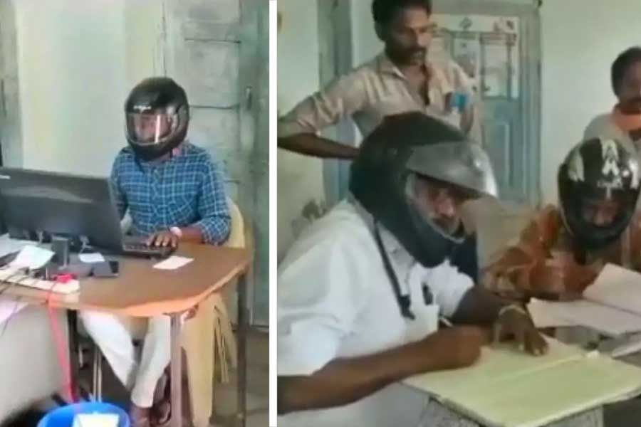 Govt employees wear helmet while working inside an office in Telangana