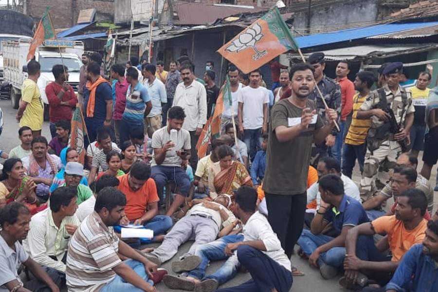 Alleged injured BJP workers lie down on the road in Bankura for protesting against indiscipline in Panchayat board formation