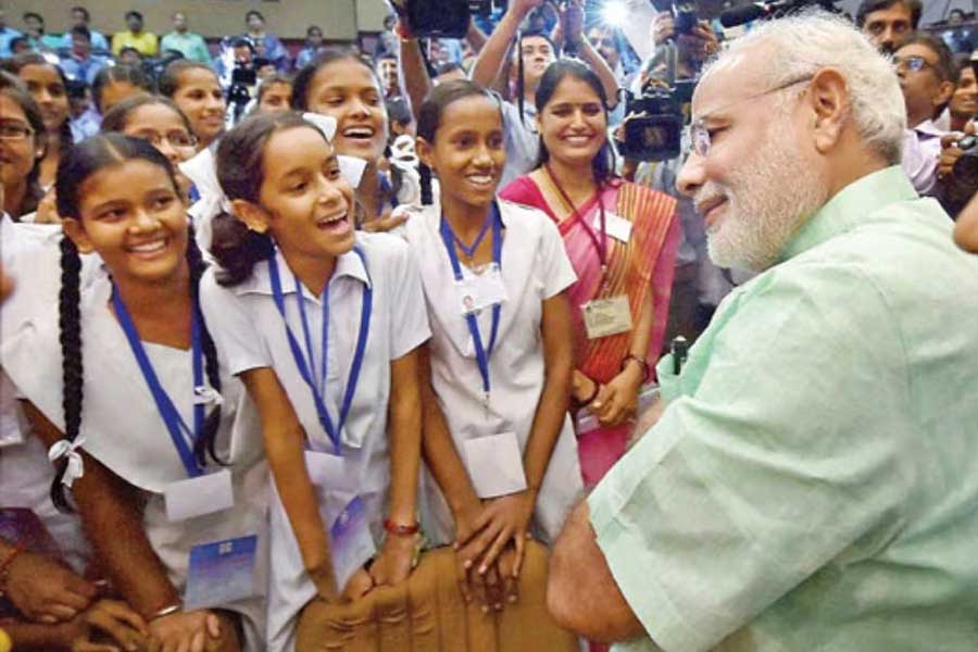 A photograph of Prime Minister Narendra Modi with school student.