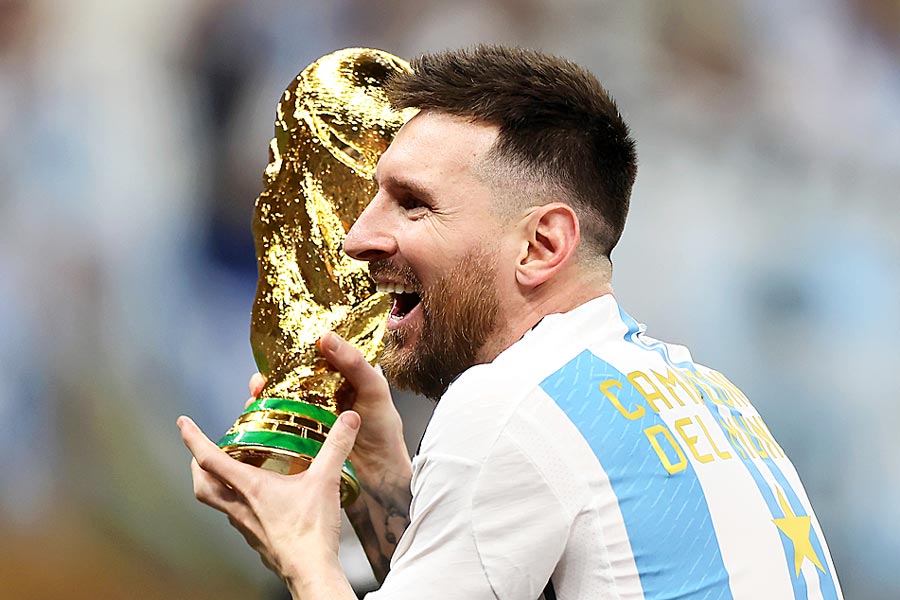 Picture of Lionel Messi holding world cup trophy
