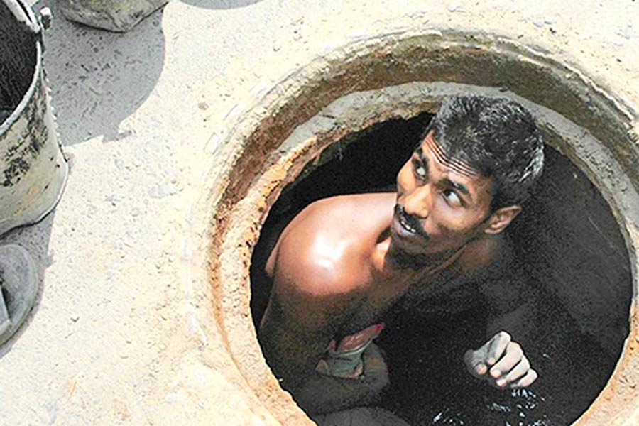 A Photograph of a man working inside the manhole 