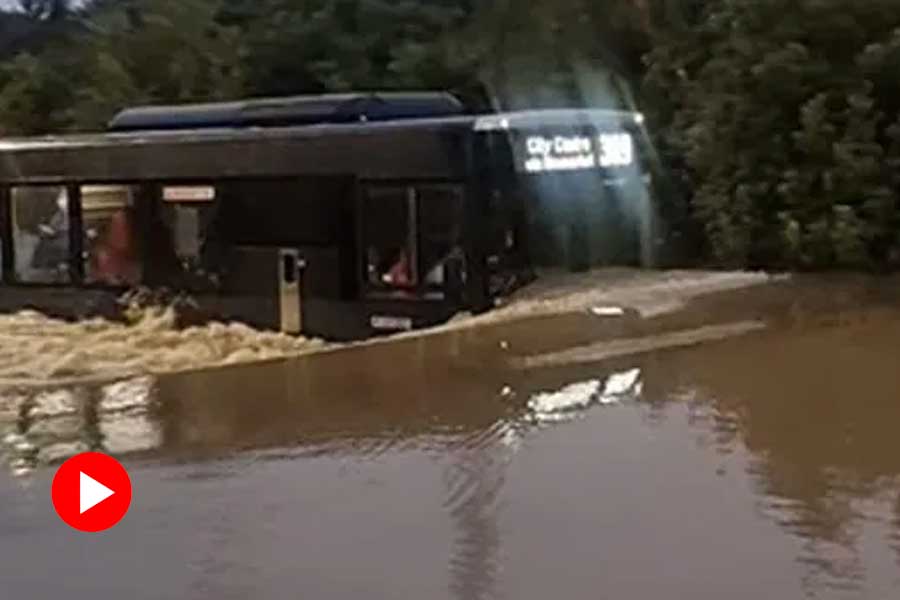 Bus runs through flooded road in Auckland