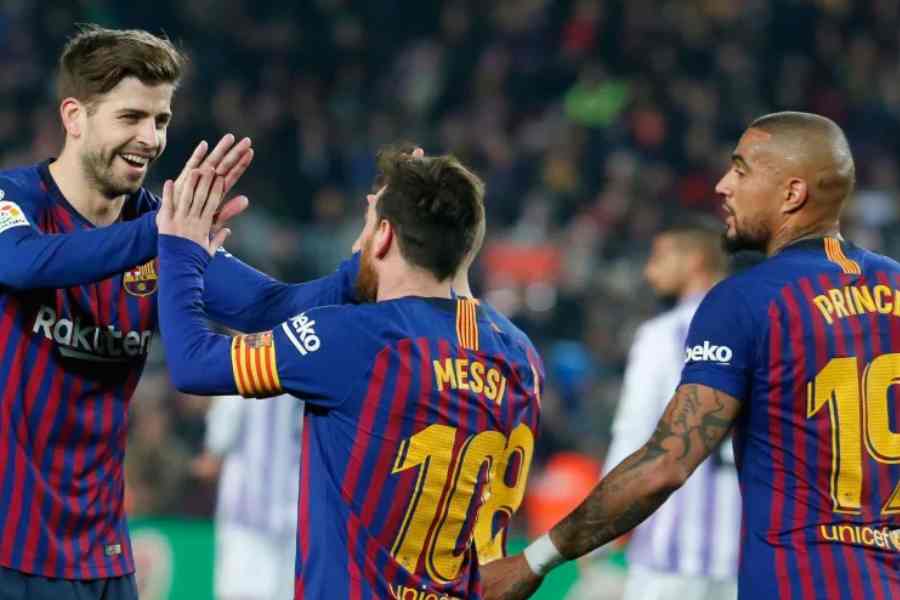 File picture of Gerard Pique, Lionel Messi and Kevin Prince Boateng in Barcelona jersey