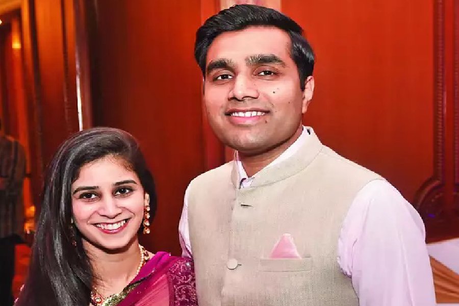 A photograph of Karan Adani and Paridhi Shroff.