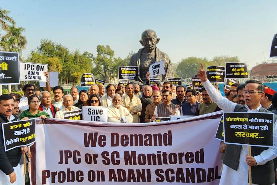 Opposition MPs join the protest near the Gandhi statue.