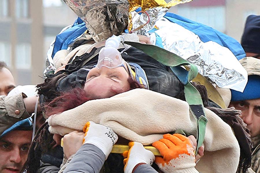 A Photograph of people rescuing others in Turkey and Syria