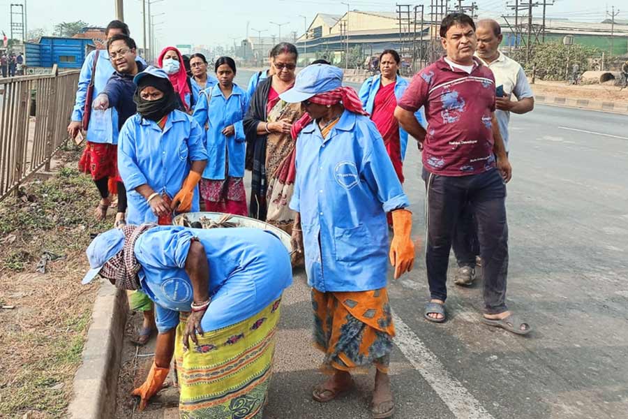 Local municipality workers cleaning road