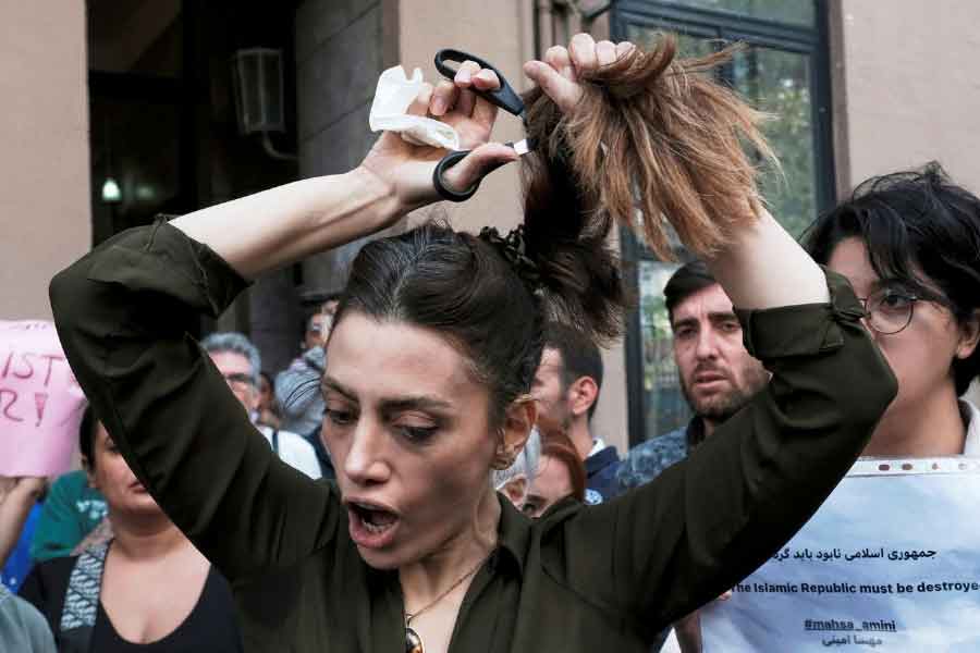 file image of a woman in tehran cutting her hair in protest