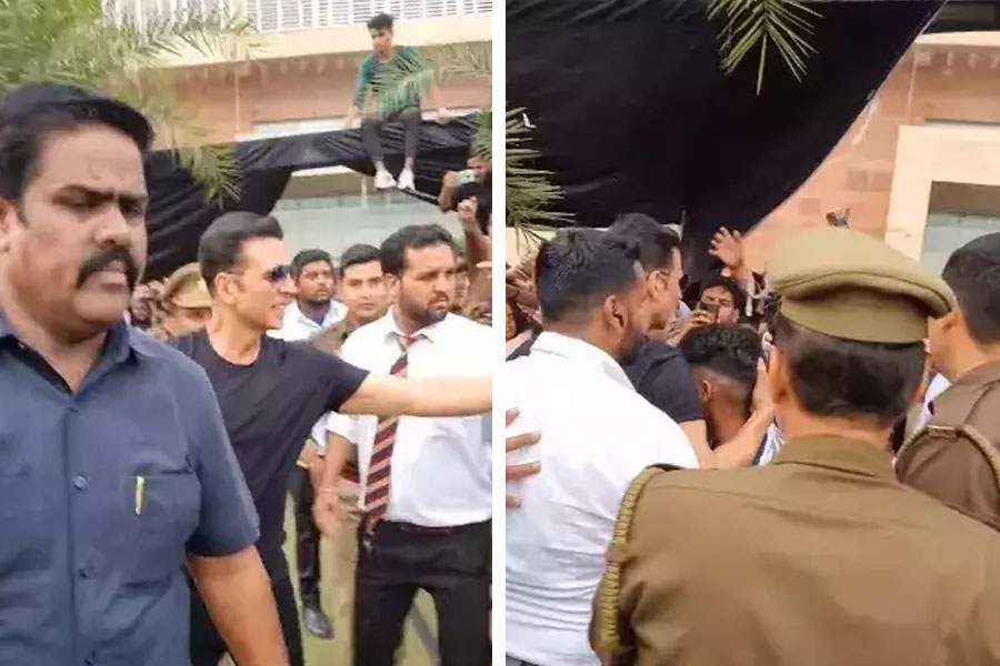Security tackles a fan who jumped over barricades to meet Akshay Kumar