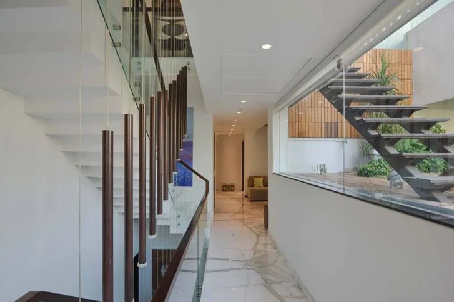 বাড়ির এক প্রান্ত থেকে অন্য প্রান্তের মধ্যে সংযোগস্থলটিও চোখধাঁধানো। চকচকে সাদা মার্বেলের মেঝে, দু’দিকে রয়েছে সিঁড়ি। নানা আসবাব এবং আলো দিয়ে সাজানো বাড়ির আনাচকানাচ।