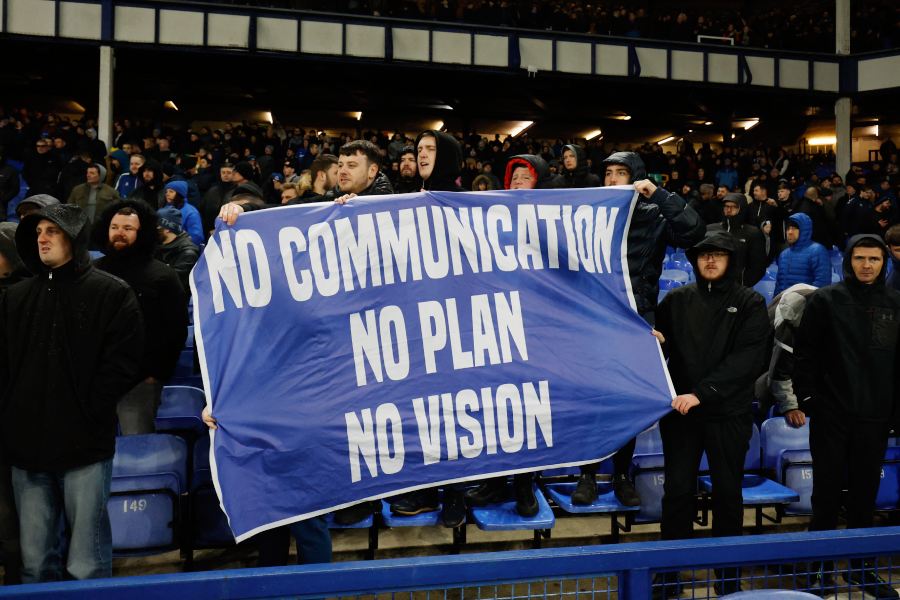 Everton fans display a banner in reference to the board after the match