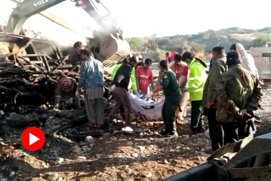Rescue team recovers the bodies of passengers of a bus that fell into a river in Pakistan