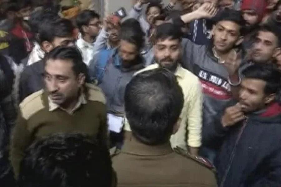 A photograph of 15 accused getting arrested from Vadodara with question papers
