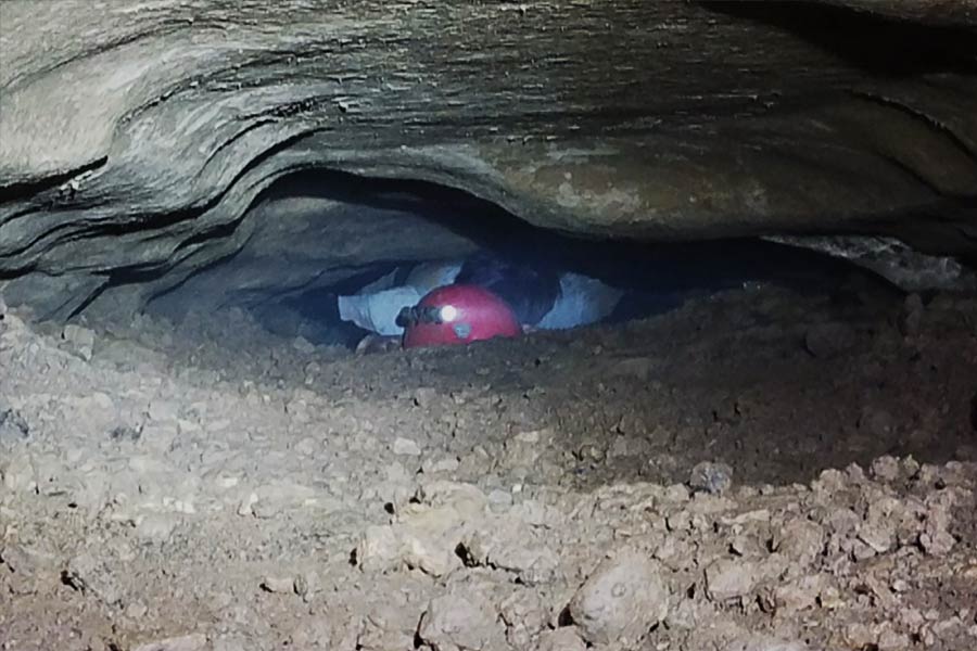  A person trying to get out from the rocks